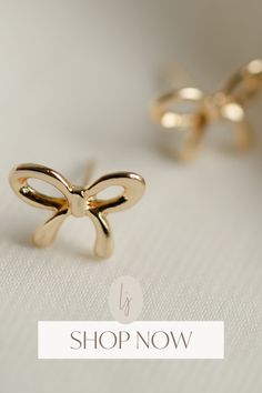 Who said bows are just for gifts? Shop Now: Gold Small Bows is here to change that perception. Add a dash of elegance, a sprinkle of fun, and a touch of glam to your outfit with these versatile gold small bows. Perfect for accessorizing or personalizing, these bows are your next fashion obsession! Shop Now! Gold Dainty Bow Earrings, Gold Dainty Earrings With Bow, Dainty Gold Earrings With Bow, Dainty Gold Bow Earrings, Chic Butterfly Knot Earrings For Gift, Chic Butterfly Knot Earrings As Gift, Gold Bow Tie Earrings For Gift, Cute Gold Bow Earrings, Gold Earrings With Bow Tie Detail For Gift