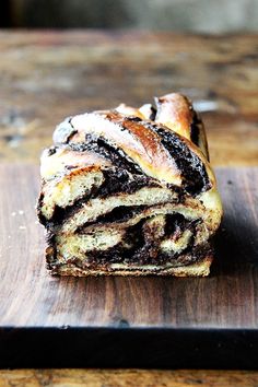 a chocolate swirl pastry sitting on top of a wooden cutting board