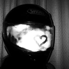 black and white photograph of a helmet with the word love written on it