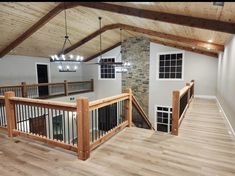 an empty living room with wood floors and exposed ceiling beams is pictured in this image