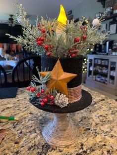 a black hat decorated with pine cones, berries and a star