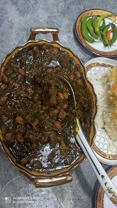 several plates with food on them including rice, beans and green chili sauce are shown