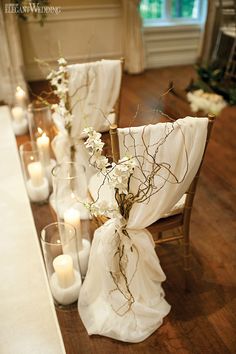 the table is set with white flowers and candles for an elegant touch to the room