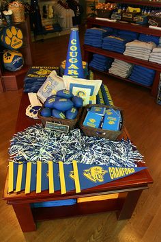 there are many items on the table for sale in this store that is decorated with blue and yellow