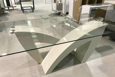 a glass table with an unusual design on it in a store or showroom,