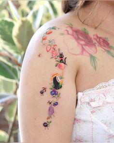 a woman with tattoos on her arm and shoulder