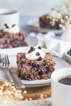 there is a piece of cake on the plate with whipped cream and blueberries in it