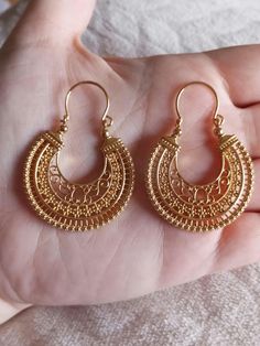 Traditional Portuguese earrings, from the Minho region, handmade using the ancestral Filigree technique, known as "Arrecadas". They are semi-jewels plated in 24-karat gold, with a stainless steel center. Big and eye-catching! New and never worn! They will be sent in our Jewelry Box or Organza Pouch, randomly. A great gift idea for her, at an affordable price, compared to sterling silver or solid gold. The exact measurements are in the photos! 😊 This material can be used in water without loosing it's gold, however you should have the typical Jewellery care with your earrings, so that no undesirable damage occurs prematurely. Check the last picture of this listing to see some other gorgeous model os "Arrecadas" Earrings we have available at the Store! Also from our Semi-Jewel collection of Portuguese Earrings, Golden Jewellery, Filigree Hoop Earrings, Organza Pouch, 24 Karat Gold, Golden Jewelry, Jewelry Earrings Hoops, Jewelry Care, Beautiful Dresses