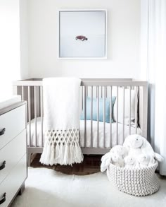 a baby's room with a crib and dresser