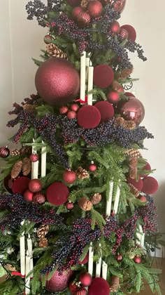 a decorated christmas tree with candles and ornaments