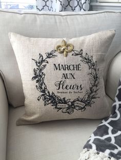 a pillow that is on top of a couch in front of a window with the words march