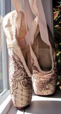 a pair of shoes sitting on top of a window sill