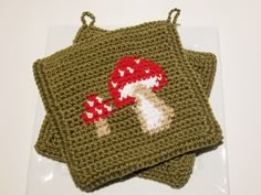 two crocheted dishcloths with mushrooms on them