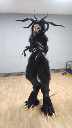 a person in a costume standing on one foot with two hands and claws attached to their body