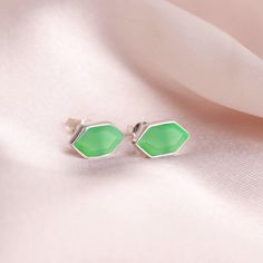 "GENERAL INFORMATION * Materials: 925 Sterling Silver * Gemstone: Chrysoprase * Style: Minimalist * Closure: Push Back * Stone Size: 11 x 6mm Hexagon * Weight: 1.6 gms * Finish: High Polish * Quantity: 1 piece ABOUT THE PRODUCT The unique hexagon shape is adorned with a beautiful 11x6mm hexagon gemstone, making them perfect for adding a touch of elegance to any outfit. The earring is also lightweight and comfortable to wear, making it a perfect choice for everyday wear.  ABOUT THE GEMSTONE Chrysoprase \"The Stone of Self Expression\" * Birthstone for May * Zodiac Sign: Gemini * Significance: Chrysoprase is a semi-precious stone that is known for its vibrant green color. The name \"chrysoprasse\" comes from the Greek words \"chrysos\" meaning \"gold\" and \"prassein\" meaning \"to strike or Minimalist Women, Minimalist Studs, May Birthstone, Women's Jewelry And Accessories, Hexagon Shape, Sterling Silver Studs, Handmade Sterling Silver, Silver Studs, Jewelry Earrings Studs