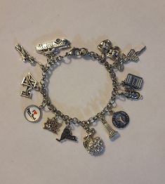 Silver New York Chain Bracelet is 7.5 inched long, however we can make it any size you need.  If you need a size different from the 7.5 inch please just note the size you need in the message to seller when placing your order and we will follow your directions.  Bracelet is stainless steel and charms are of various different metals.  Bracelet comes with every charm shown in the photos.  Photo number 2 labels all of the charms.  We do have a few other charms should you want to swap one or two out.  We have a pretzel, horse and buggy (Central Park), Double Decker New York Bus, helicopter and shopping bag. Please feel free to message us with any questions you may have.  Thank you so much! New York Jewelry, Charmed Show, Horse And Buggy, Double Decker Bus, Taxi Cab, Bracelet Chain, Silver Charm Bracelet, Inspired Jewelry, Bracelet Charm