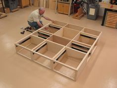 a man is working on some wooden furniture