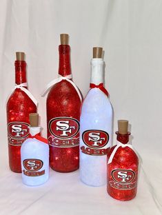 red and white bottles with san francisco giants decals on the top are lined up against a white background