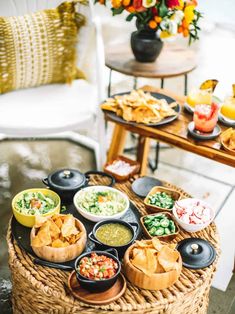 a table filled with different types of food on plates and bowls next to each other