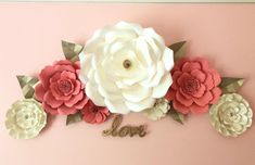 paper flowers and the word love on a pink background