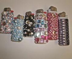 a group of different colored and shaped cell phones on a white surface with pearls attached to them