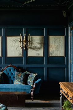 a blue couch sitting next to a wooden table