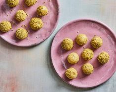 two pink plates with balls of food on them