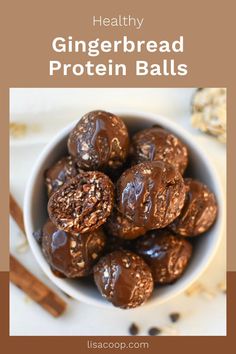 a white bowl filled with chocolate covered gingerbread protein balls on top of a table