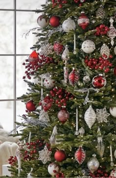 a decorated christmas tree with red and white ornaments