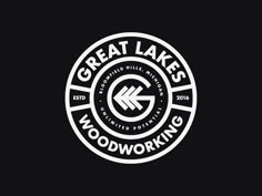 the great lakes woodworking logo is shown in white on a black background, with an arrow