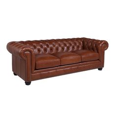 a brown leather couch sitting on top of a white floor