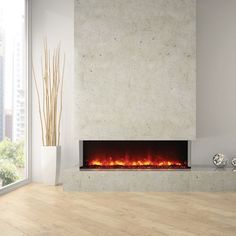 a modern fireplace in a living room with wood flooring and large windows overlooking the city