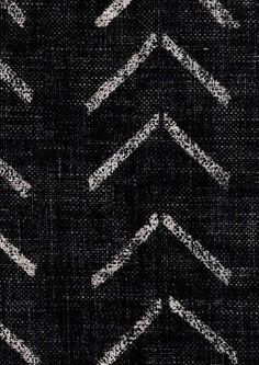 an upholstered black and white fabric with arrows drawn on it