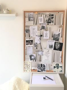 a white desk topped with lots of pictures and papers