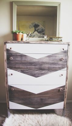 an old dresser has been painted with white and brown chevrons on it's drawers