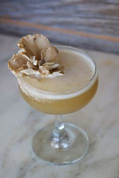 a close up of a drink in a glass on a table