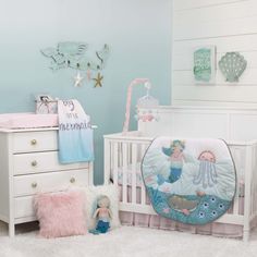 a baby's room is decorated in pastel blue, pink and white colors