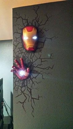 two iron man masks mounted to the side of a wall