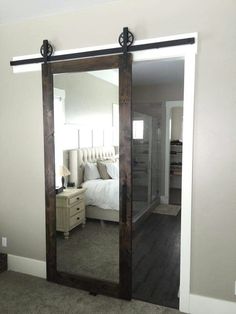 a bedroom with a large mirror on the wall