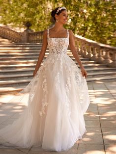 a woman in a wedding dress walking down the street