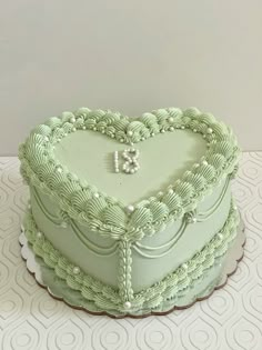 a heart shaped green cake on a table