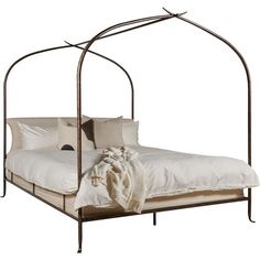 an iron bed frame with white sheets and pillows on the bottom, in front of a white background