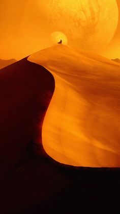 the sun is setting over a desert landscape