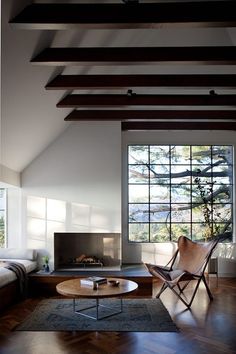 a living room filled with furniture and a fire place in the middle of a room