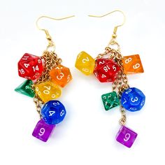 two pairs of multicolored dice earrings with numbers on each side and dangling chain