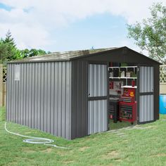 a metal shed sitting on top of a lush green field next to a swimming pool