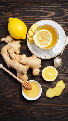 a cup of tea with lemons and ginger next to it