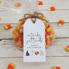 a bag filled with candy corn sitting on top of a wooden table