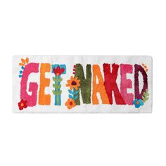 a white door mat with the word get naked painted on it in multicolors