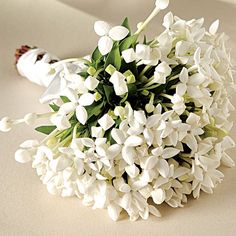 a bouquet of white flowers sitting on top of a table